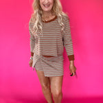 Side view showing the vertical seam detail and waist-length cropped fit of the striped long sleeve top