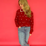 Back view of the red heart print knit sweater showing its smooth, lightweight drape