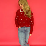 Back view of the red heart print knit sweater showing its smooth, lightweight drape