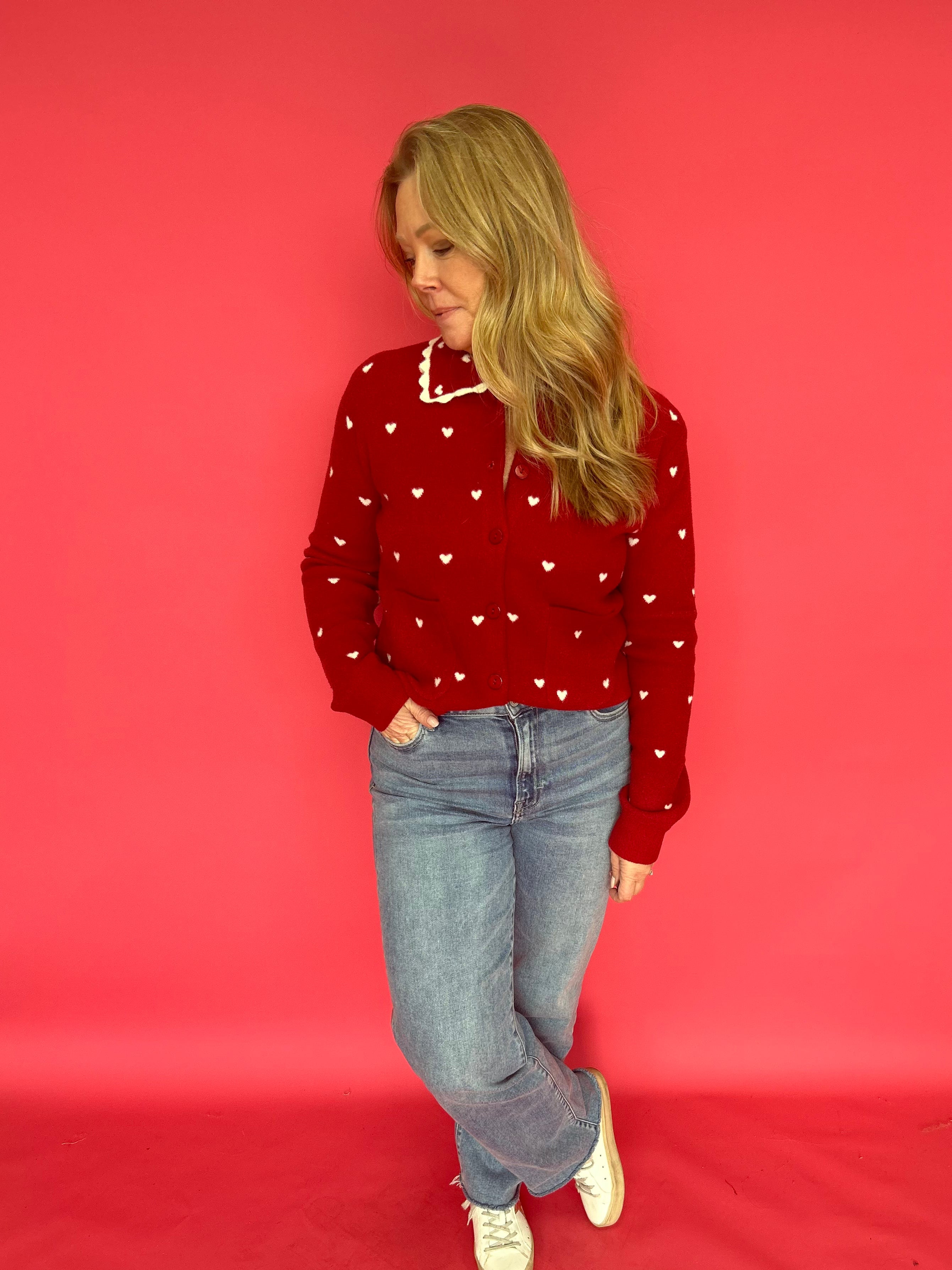 Back view of the red heart print knit sweater showing its smooth, lightweight drape