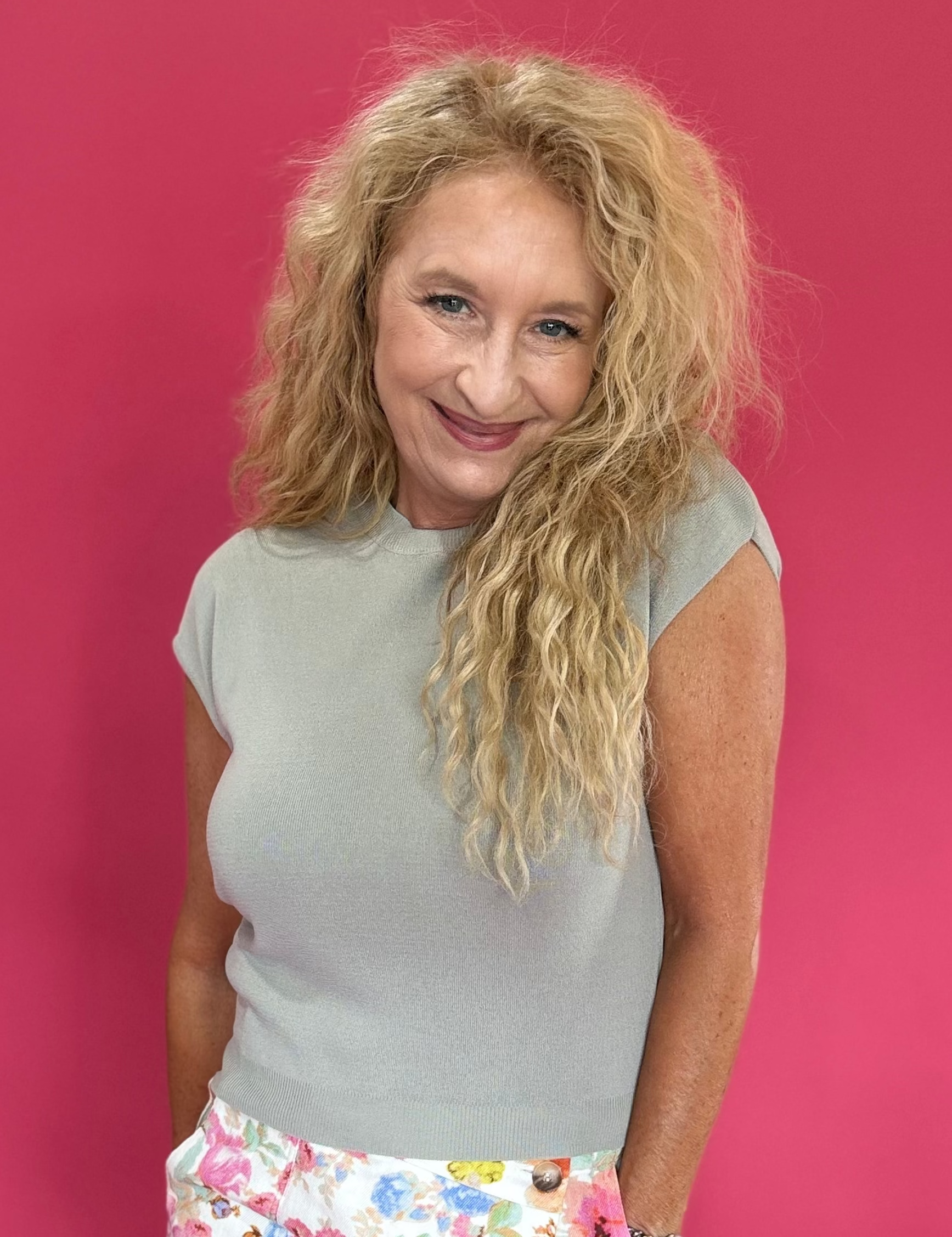 Woman wearing a gray knit cap sleeve tee with a round neckline and wide leg trousers