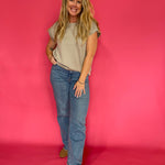 Side view showing the polished drape and short sleeves of the mocha scuba knit top