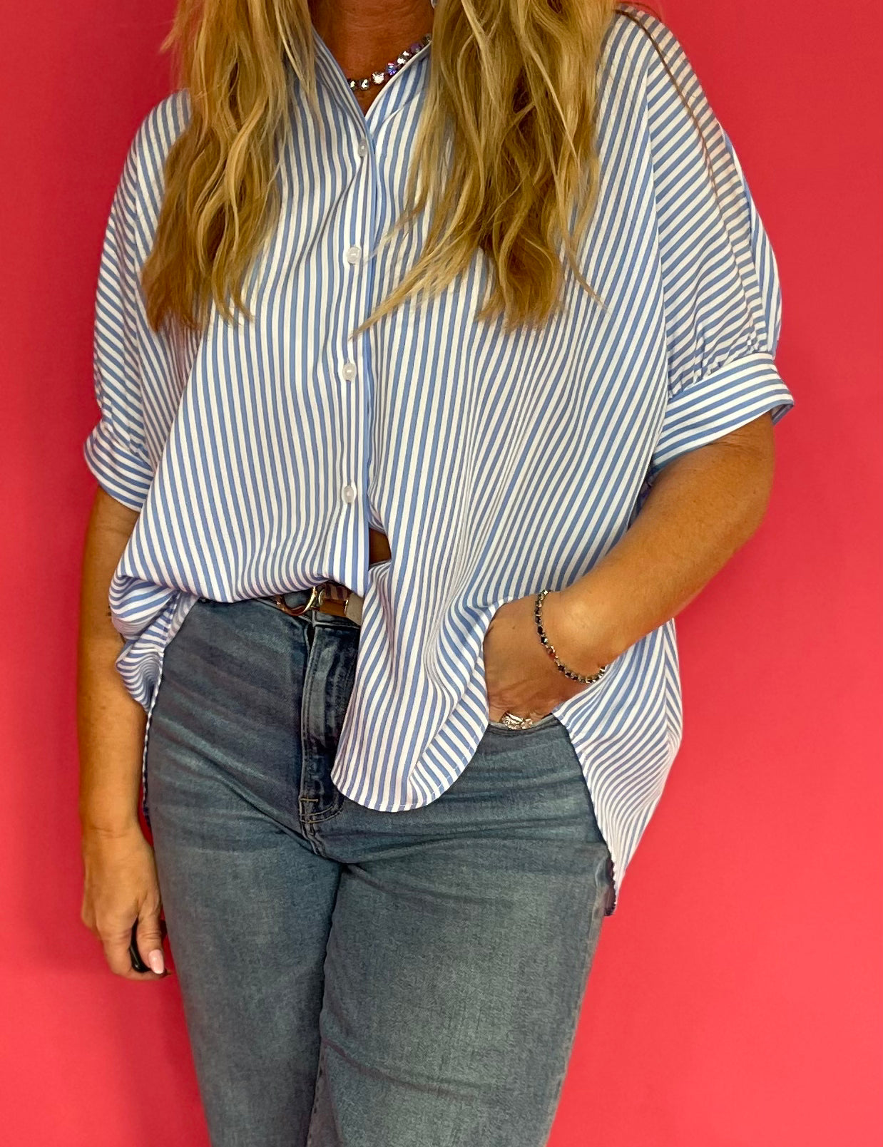 Back view of the oversized blue button down showing its drapey relaxed silhouette