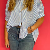 Back view of the oversized blue button down showing its drapey relaxed silhouette