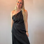 Flat lay of the black one-shoulder midi dress showing the asymmetrical neckline and draped bodice