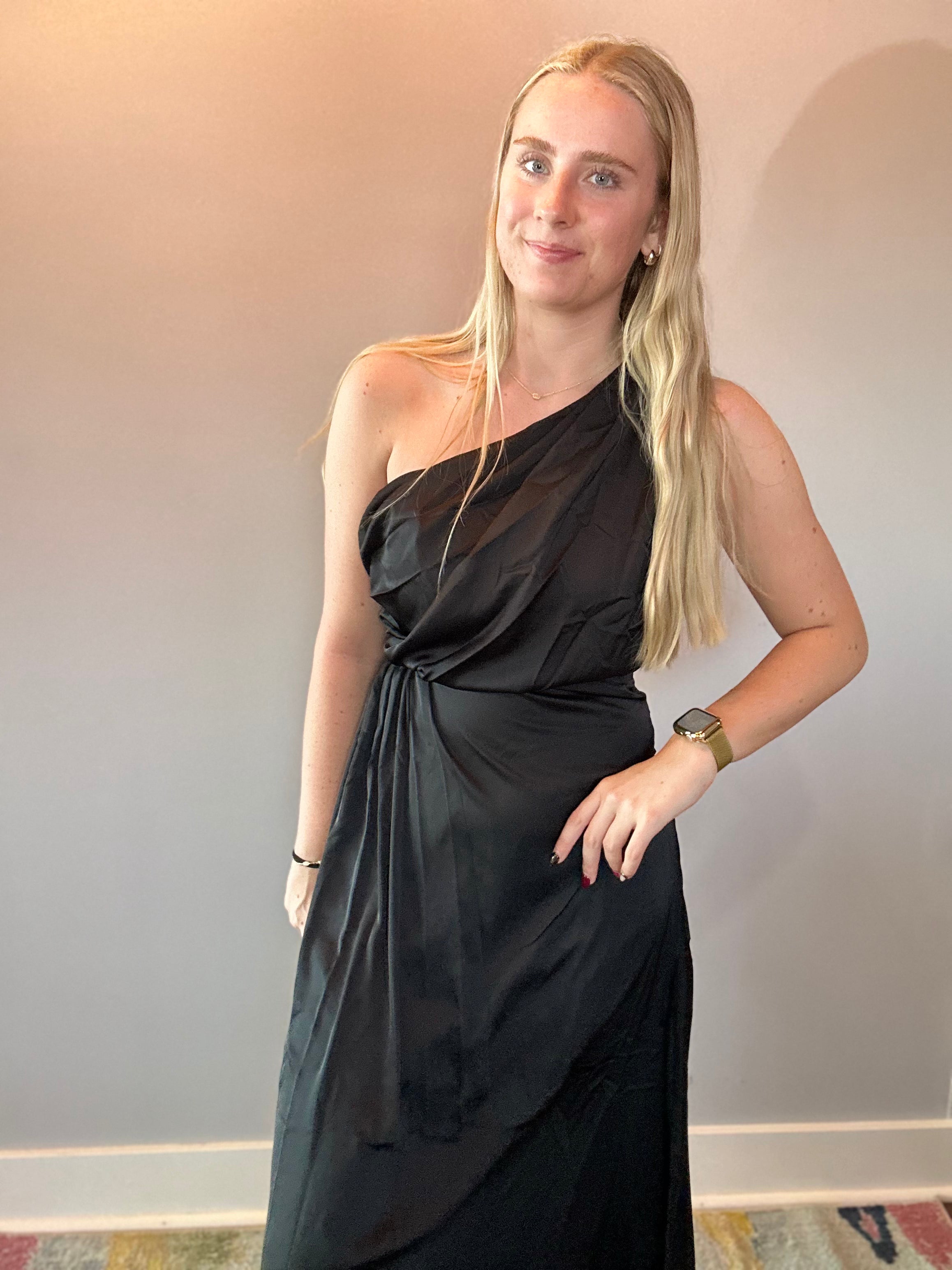 Detail of the lightweight woven fabric and soft movement in the skirt of the black midi dress