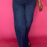 Woman wearing Curator wash wide leg jeans with a raw hem and a fitted tee tucked in