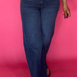 Woman wearing Curator wash wide leg jeans with a raw hem and a fitted tee tucked in