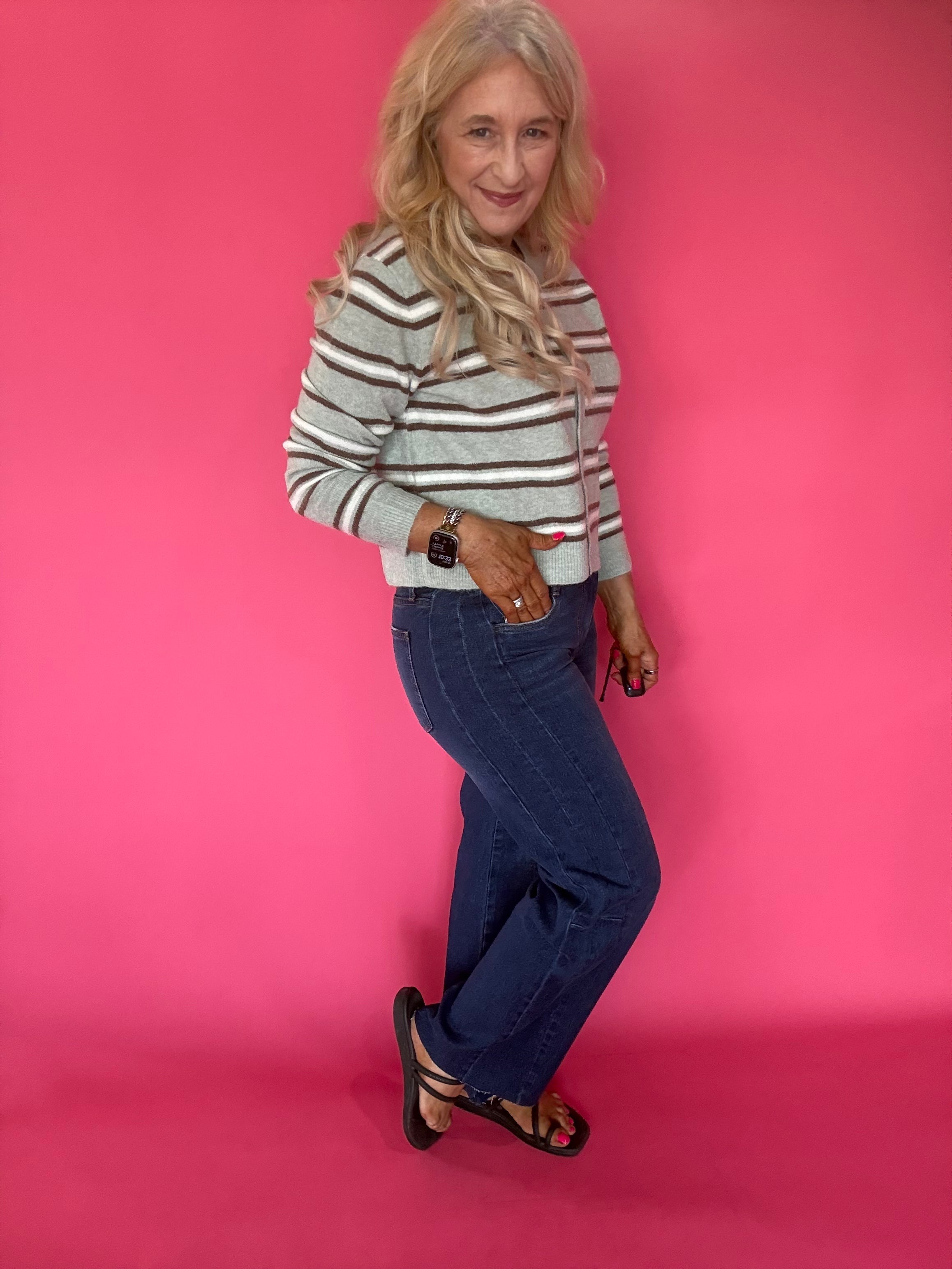 Side view showing the 29 inch inseam of the Curator wash wide leg jeans with sneakers