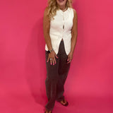 Back view of the ivory sleeveless knit vest showing the longline silhouette and split hem