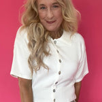Woman wearing a lightweight short sleeve button front knit cardigan with a soft collar