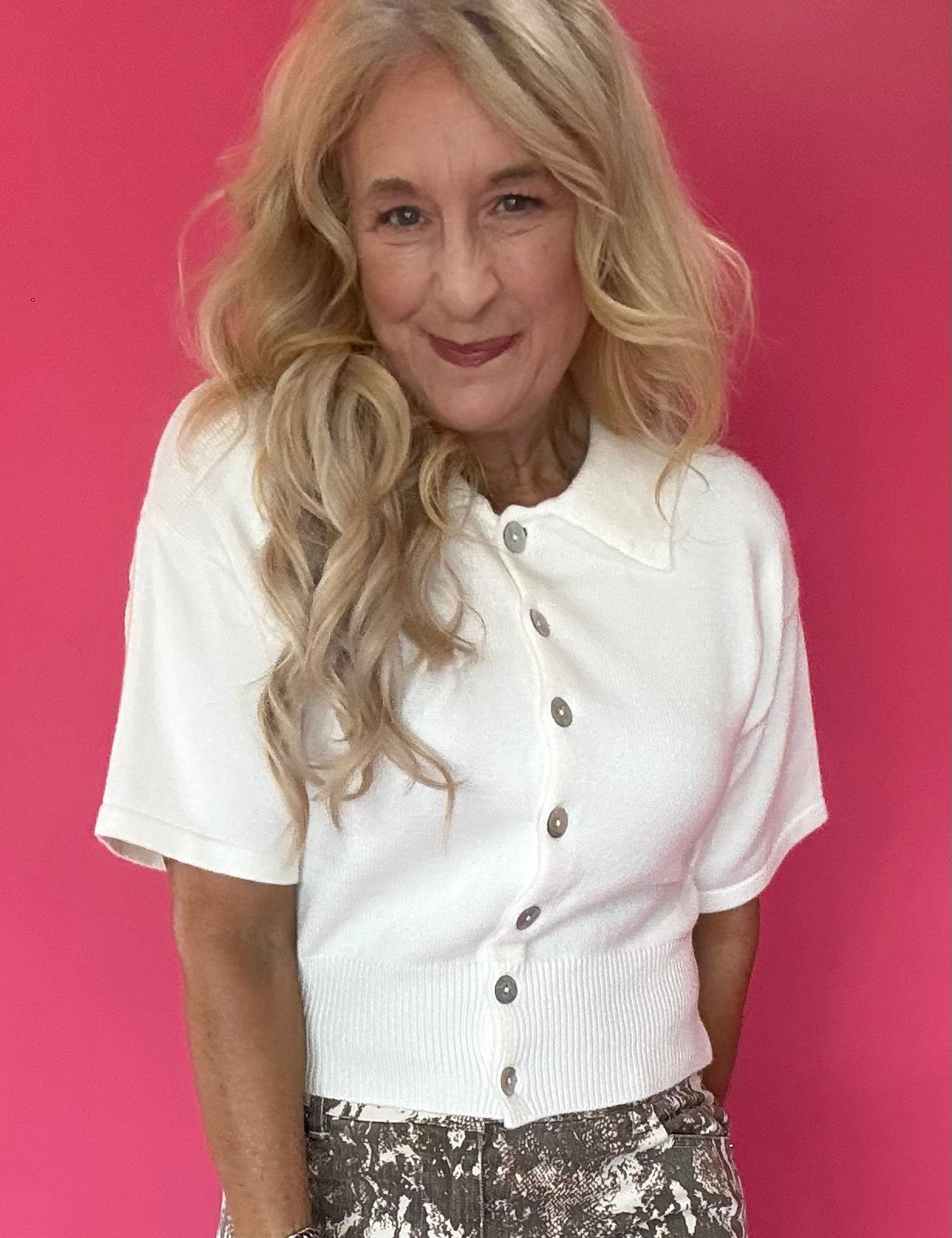 Woman wearing a lightweight short sleeve button front knit cardigan with a soft collar