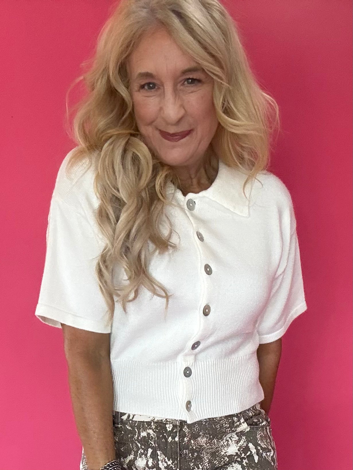 Woman wearing a lightweight short sleeve button front knit cardigan with a soft collar