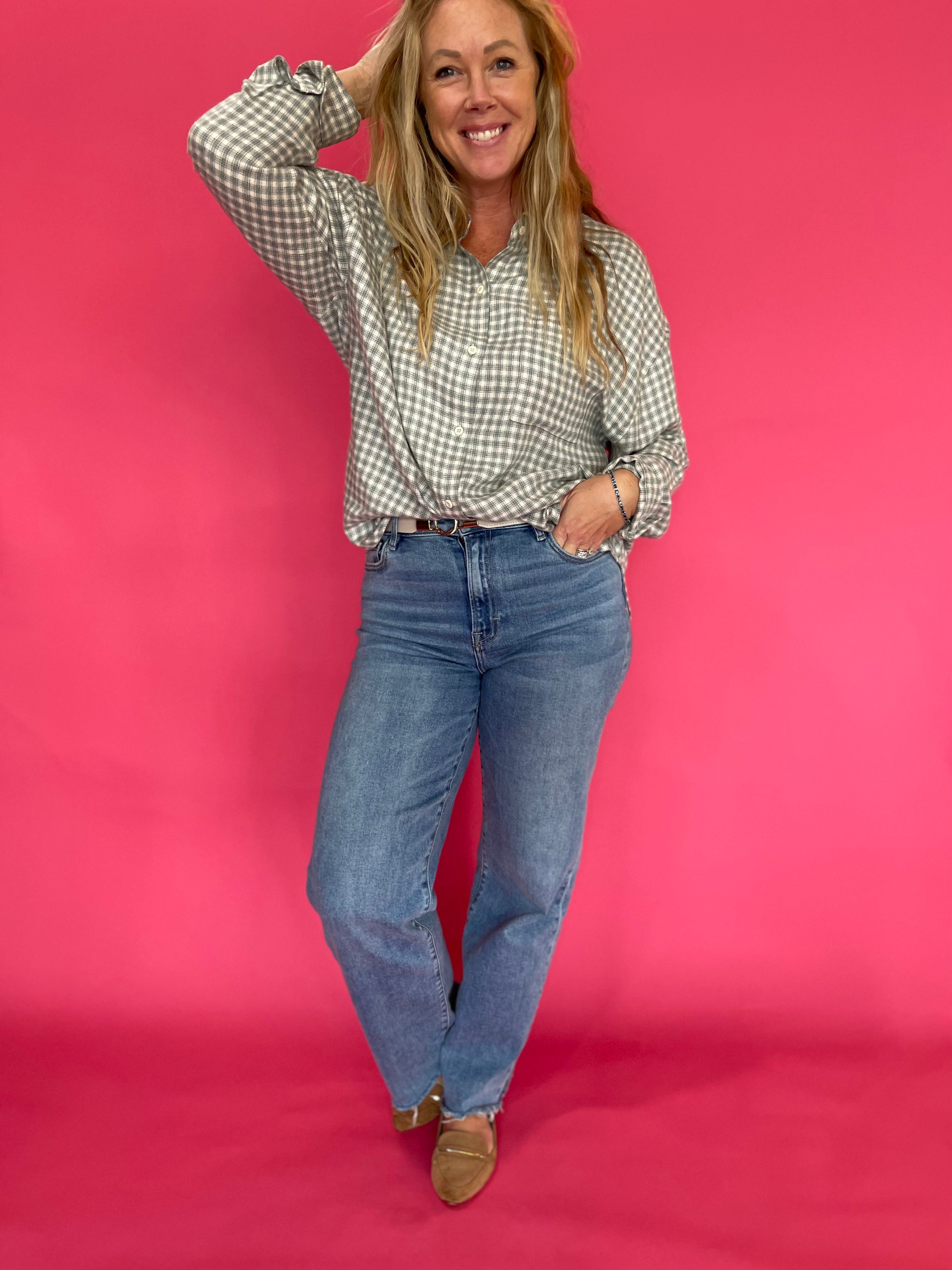 Emerald plaid flannel shirt front tucked into black jeans with ankle boots for fall