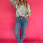 Emerald plaid flannel shirt front tucked into black jeans with ankle boots for fall