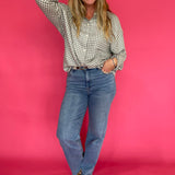 Emerald plaid flannel shirt front tucked into black jeans with ankle boots for fall