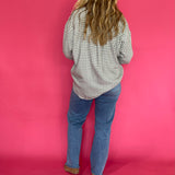 Full length view of the emerald green plaid flannel shirt worn open over a fitted tank