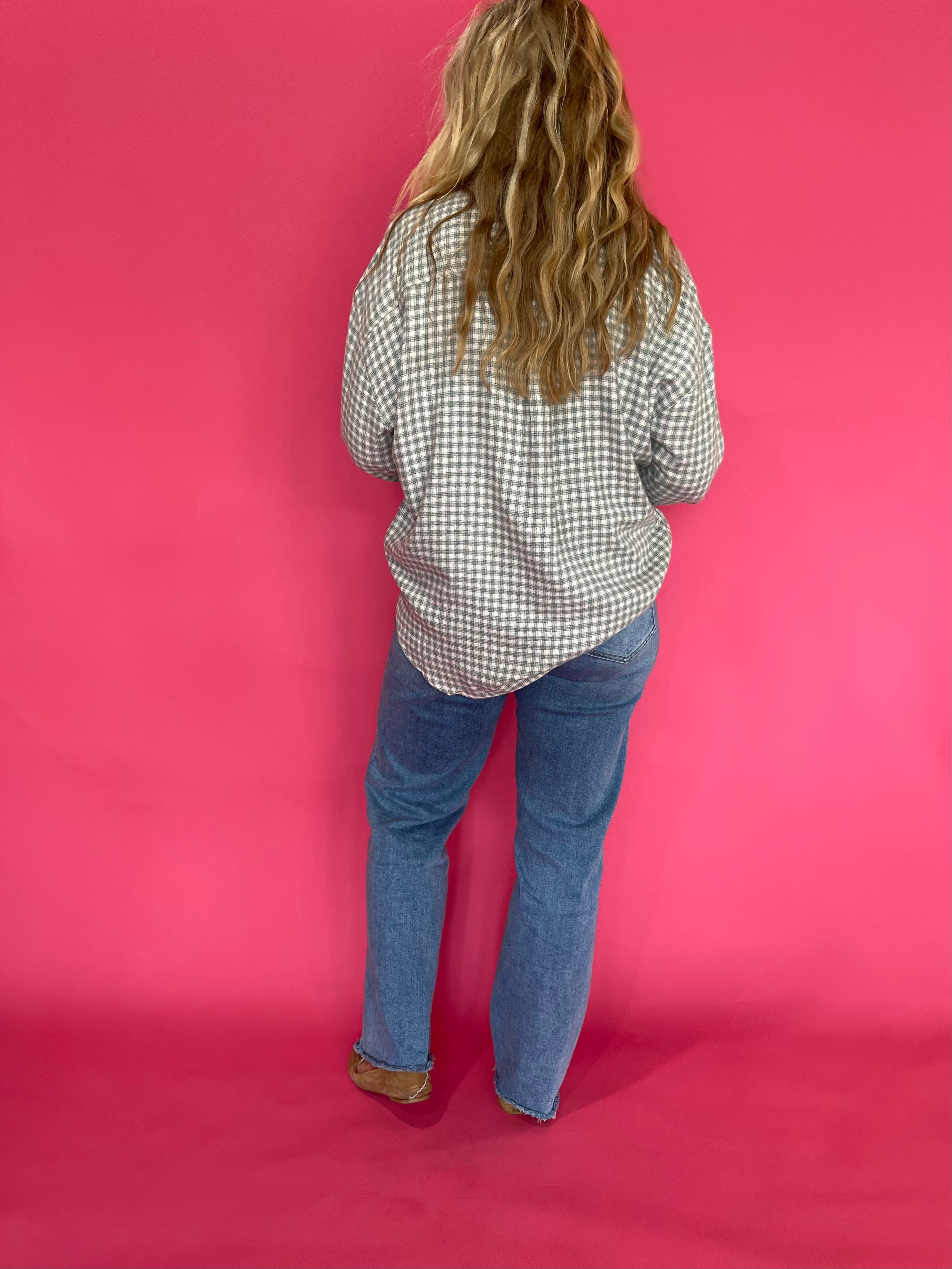 Full length view of the emerald green plaid flannel shirt worn open over a fitted tank