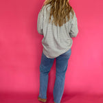 Full length view of the emerald green plaid flannel shirt worn open over a fitted tank