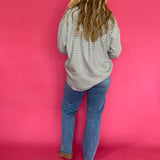 Full length view of the emerald green plaid flannel shirt worn open over a fitted tank