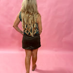 Side view showing the built-in hidden shorts under the brown faux suede mini skort