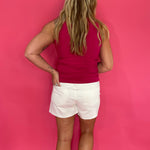 Pink ribbed tank front tucked into denim with gold jewelry for an easy casual look