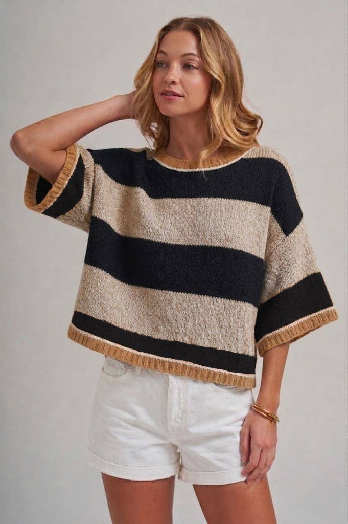 Side view of the wide stripe drop shoulder sweater in blue and brown, worn loose over the hip