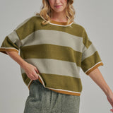 Three quarter view of the loose fit blue and brown striped sweater top styled for casual fall wear