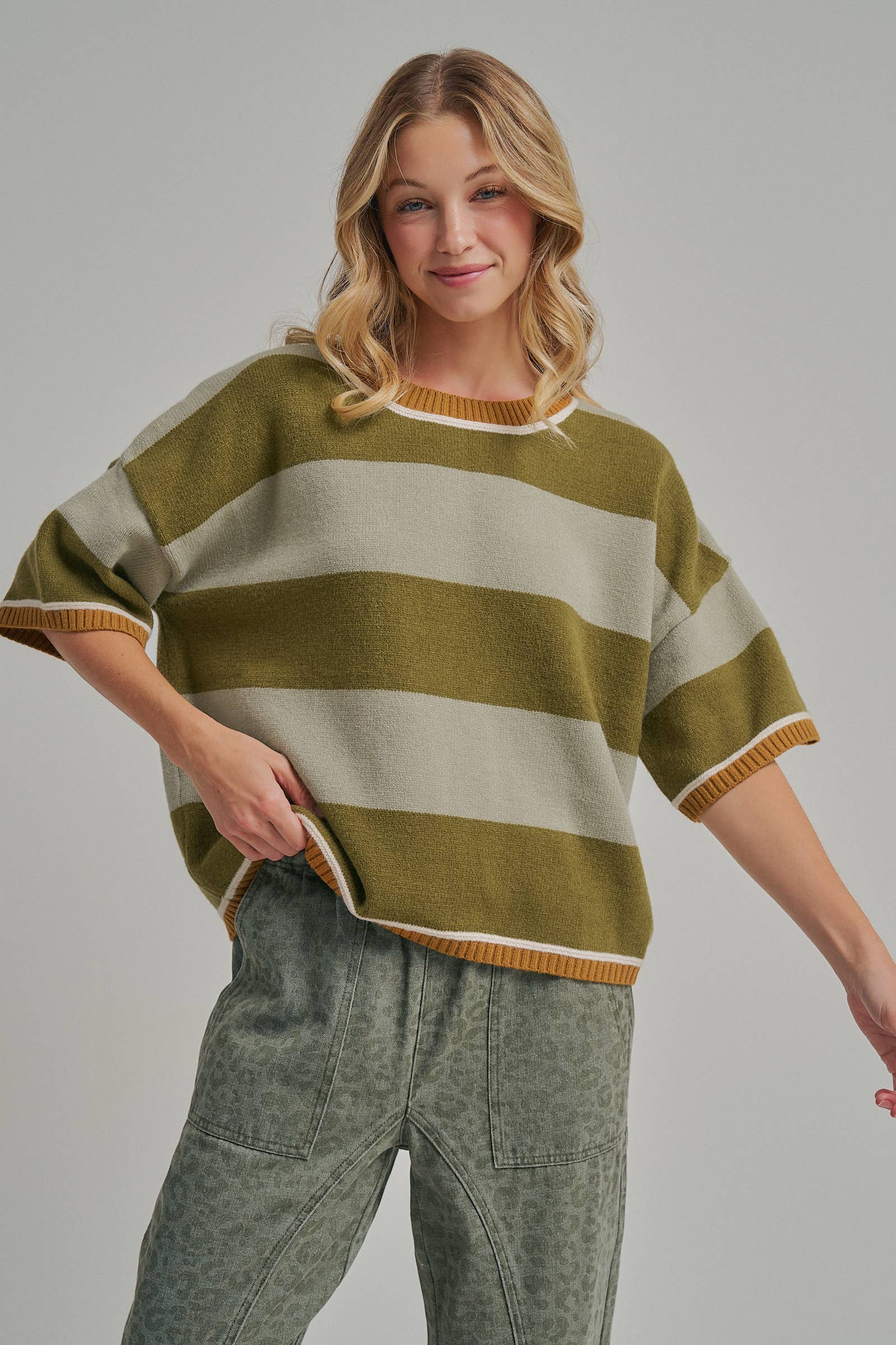 Three quarter view of the loose fit blue and brown striped sweater top styled for casual fall wear