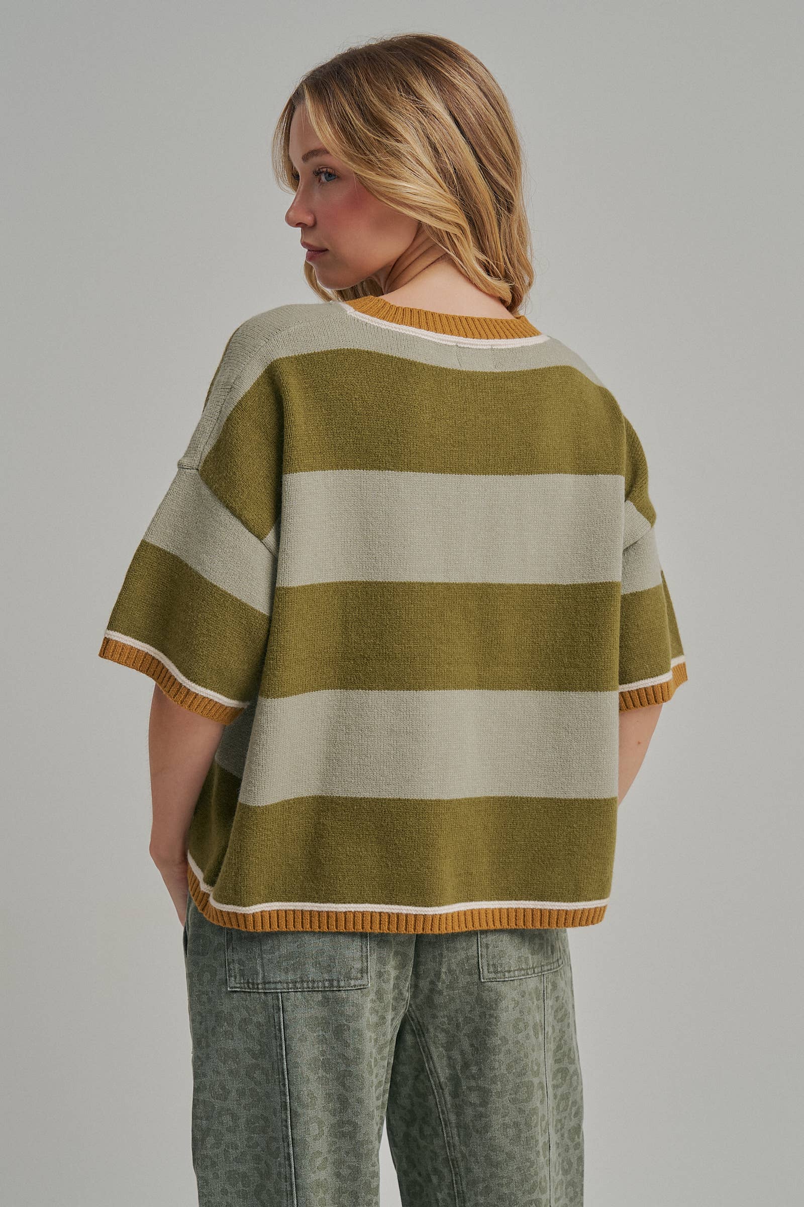 Full length view of the blue and brown wide stripe loose fit sweater top styled as an easy outfit
