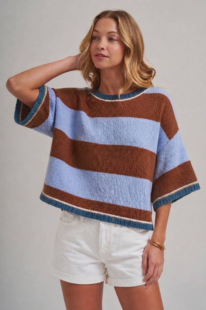 Woman wearing a blue and brown wide stripe drop shoulder sweater top in a loose, easy everyday fit