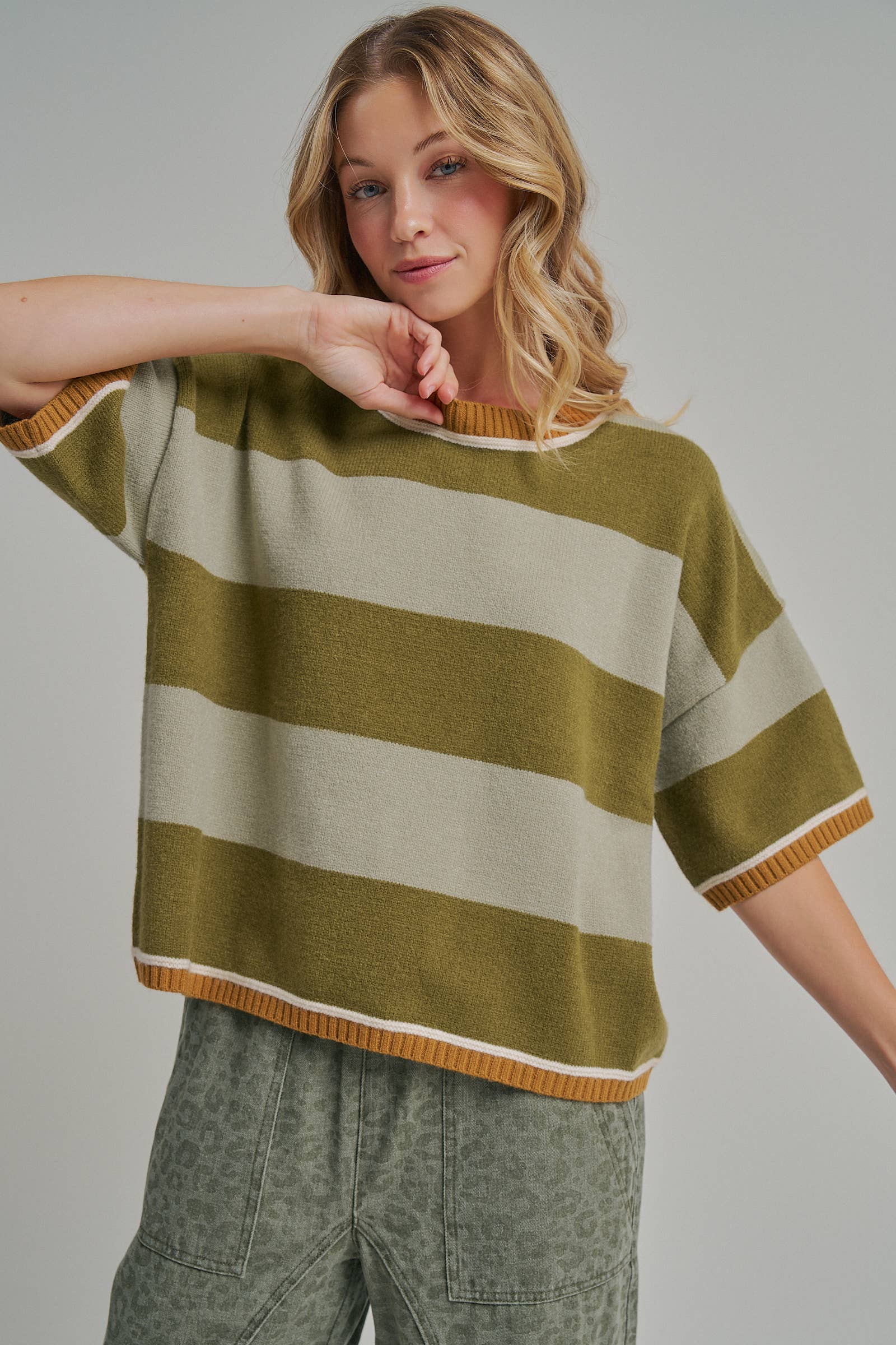 Detail of the dropped shoulder seam on the blue and brown wide stripe loose fit sweater top