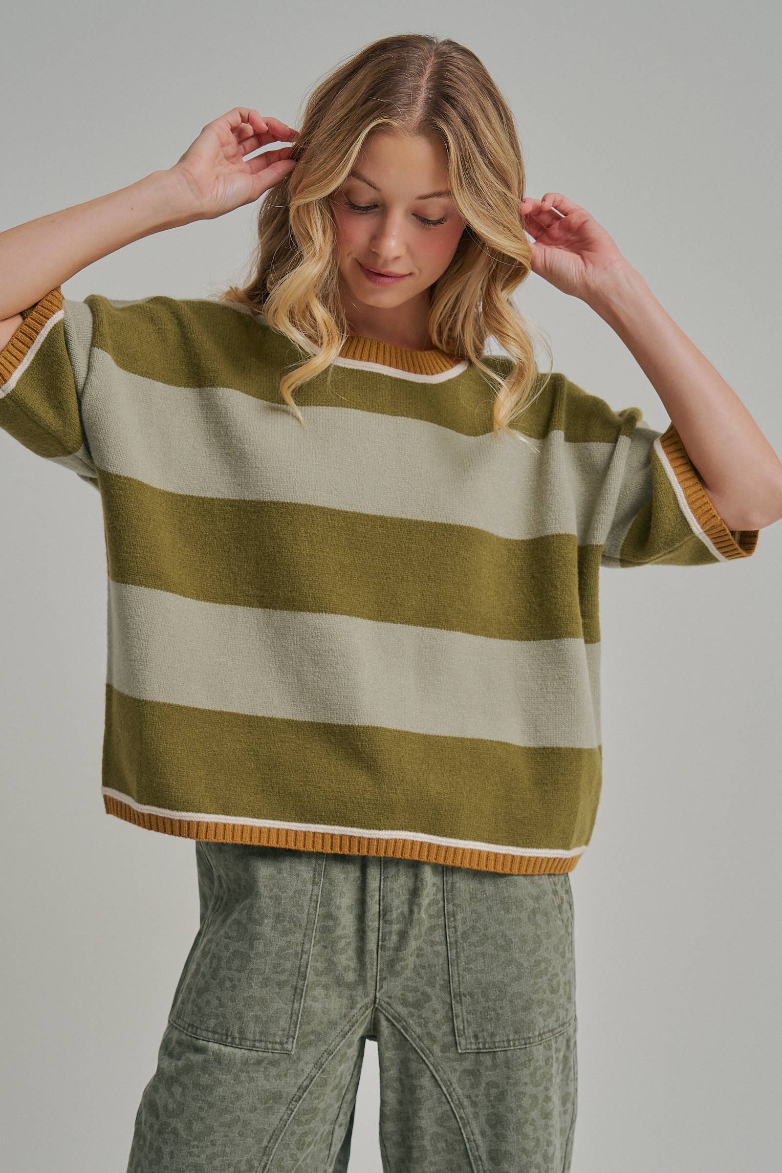 Close-up of the neckline and upper stripes on the blue and brown drop shoulder sweater top