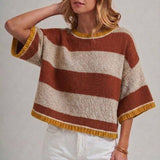 Close-up of the wide horizontal stripe pattern in blue and brown on the soft knit sweater top