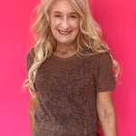Woman wearing a mocha open knit crochet sweater tee with a crew neckline and short sleeves
