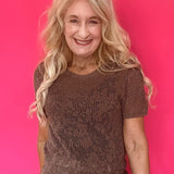 Woman wearing a mocha open knit crochet sweater tee with a crew neckline and short sleeves
