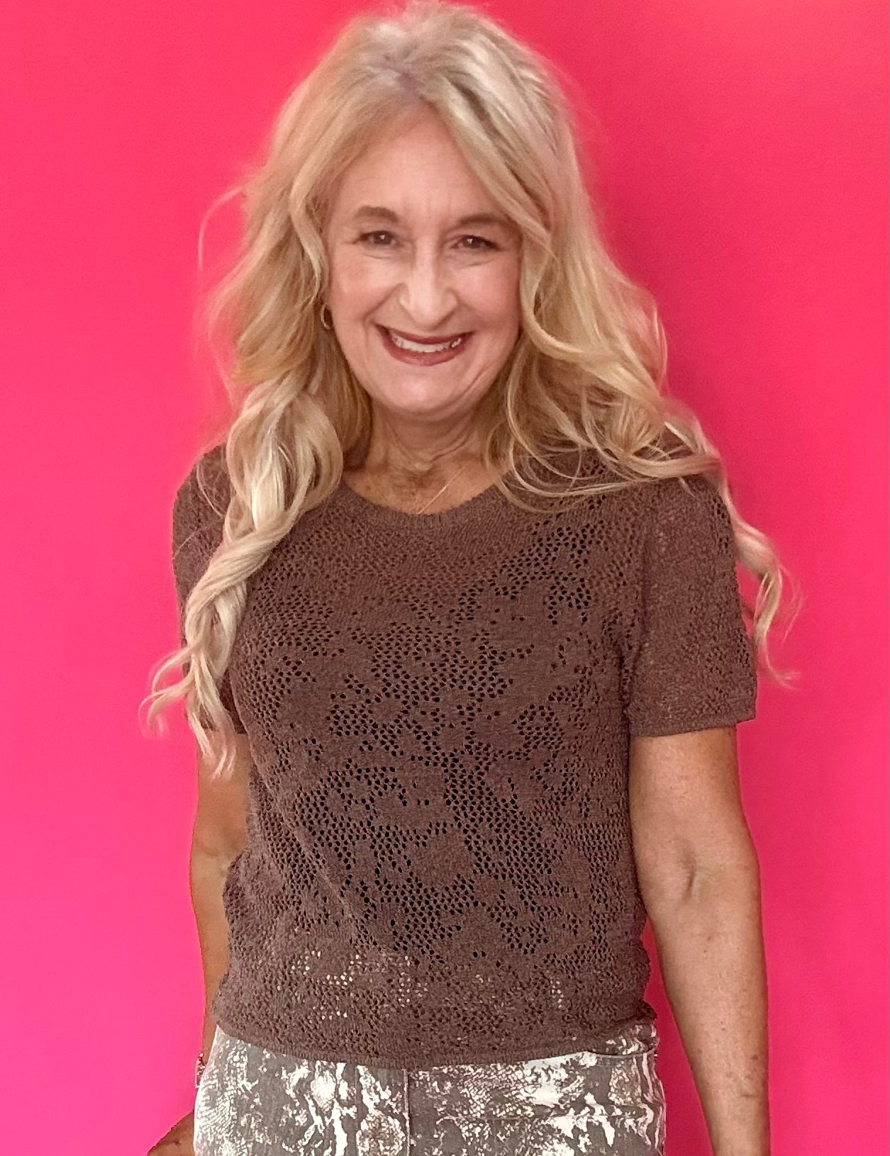 Woman wearing a mocha open knit crochet sweater tee with a crew neckline and short sleeves