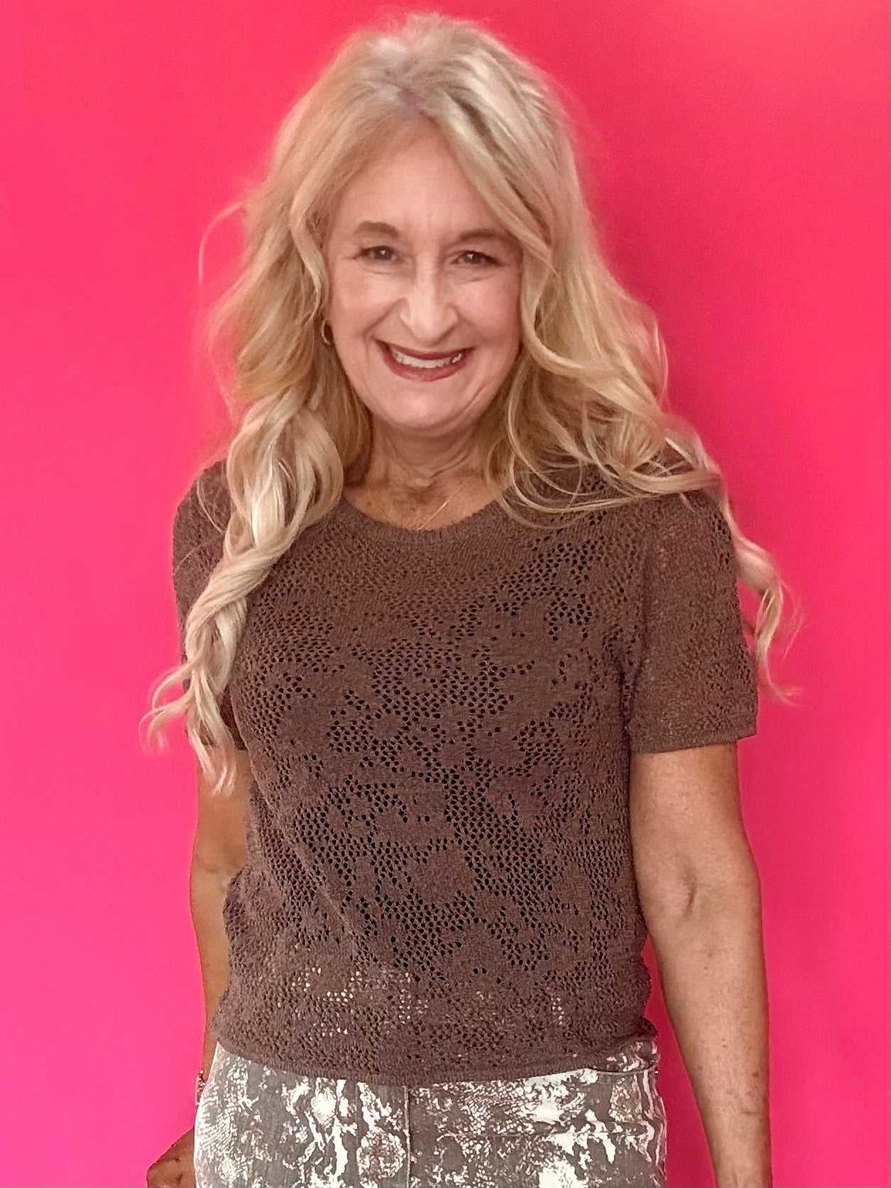Woman wearing a mocha open knit crochet sweater tee with a crew neckline and short sleeves