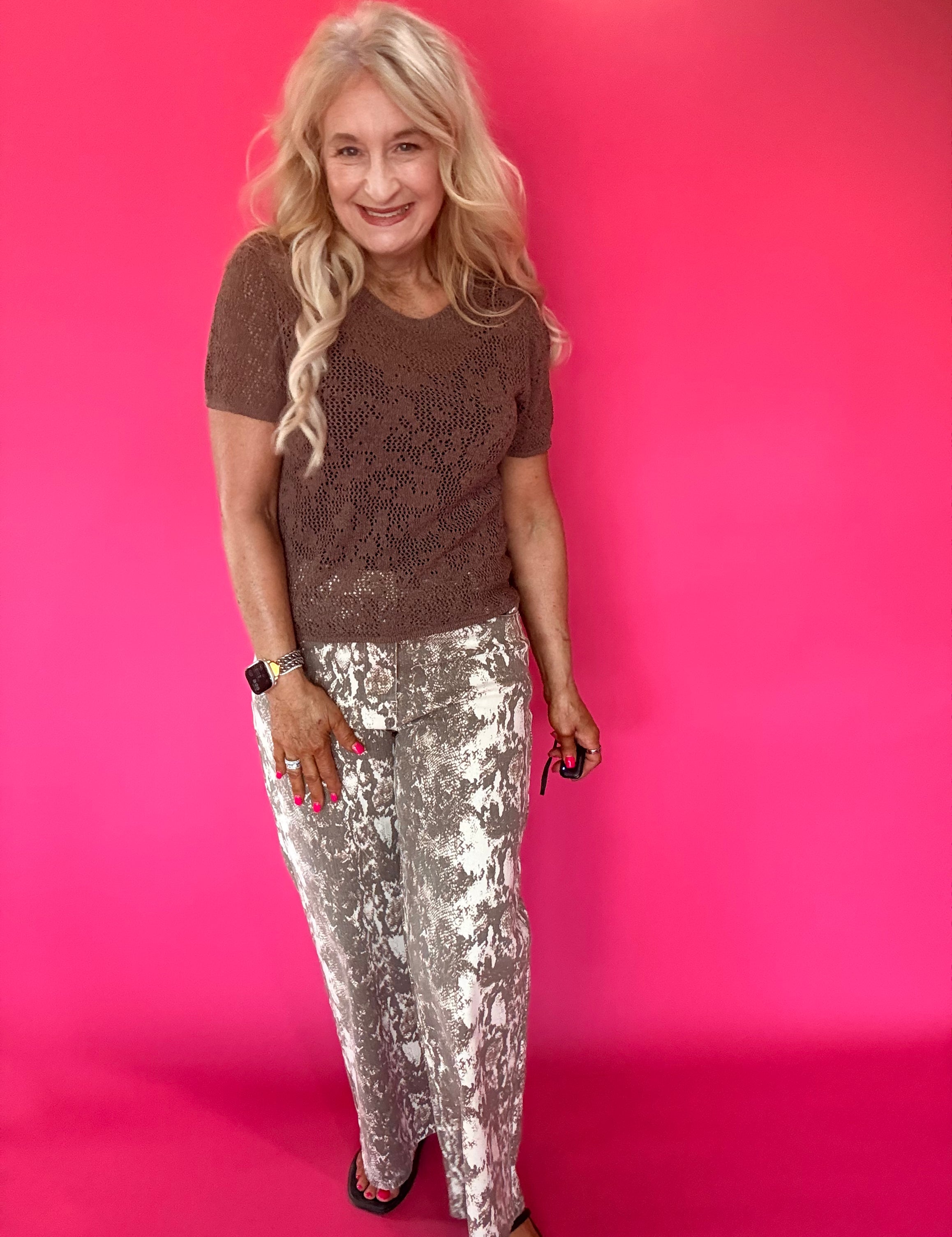 Close-up of the soft ecru snake print pattern on the lightweight woven pant fabric