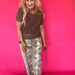 Close-up of the soft ecru snake print pattern on the lightweight woven pant fabric