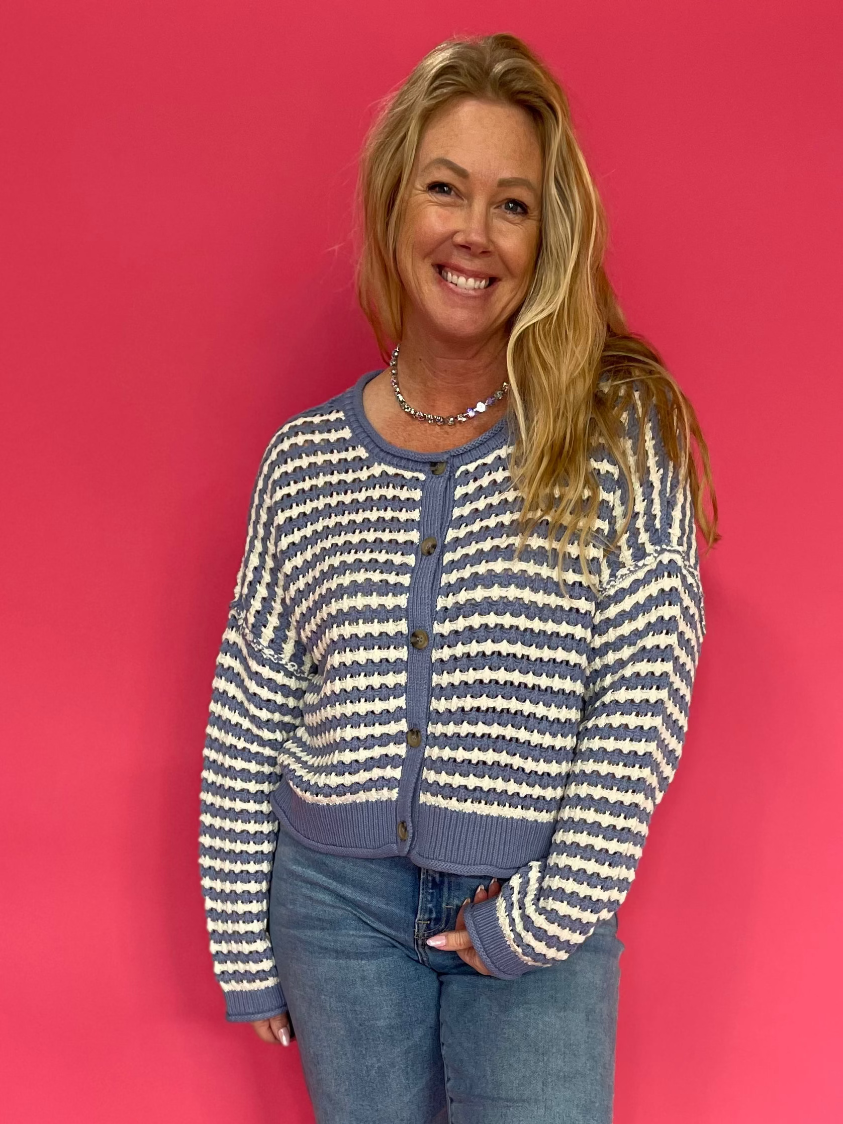 Woman wearing a chocolate brown soft knit sweater with a relaxed everyday fit and blue jeans