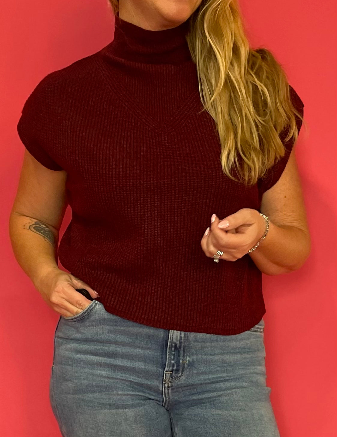 Close-up of the textured rib knit and mock neckline on the wine cap sleeve sweater