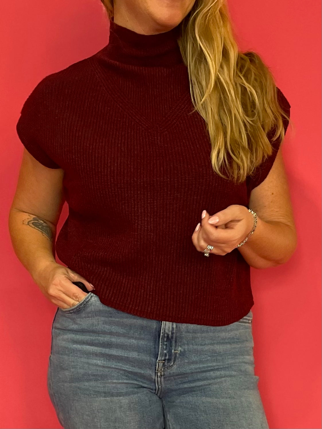 Close-up of the textured rib knit and mock neckline on the wine cap sleeve sweater