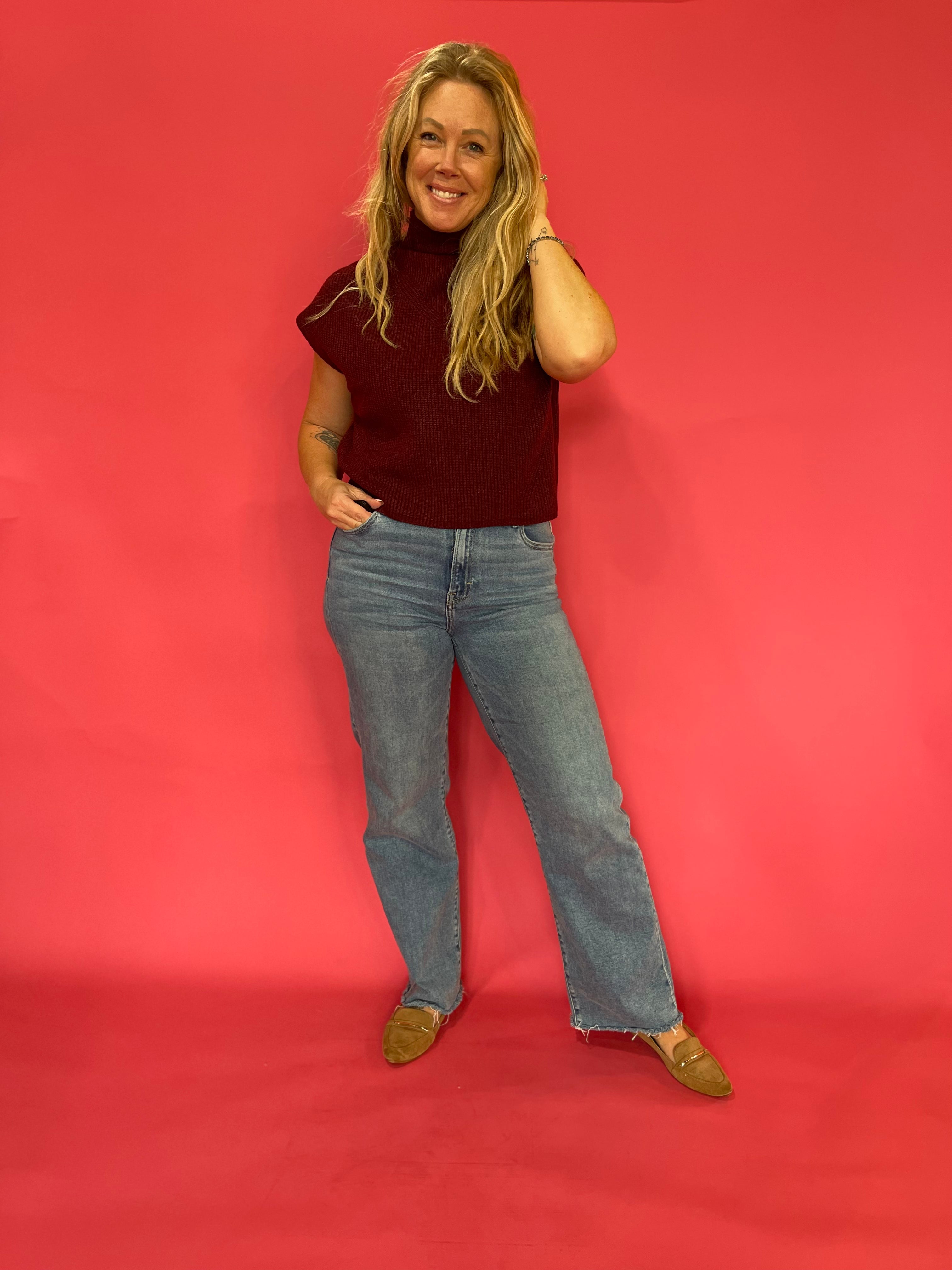 Side view of the wine mock neck sweater showing the cap sleeve and medium weight knit